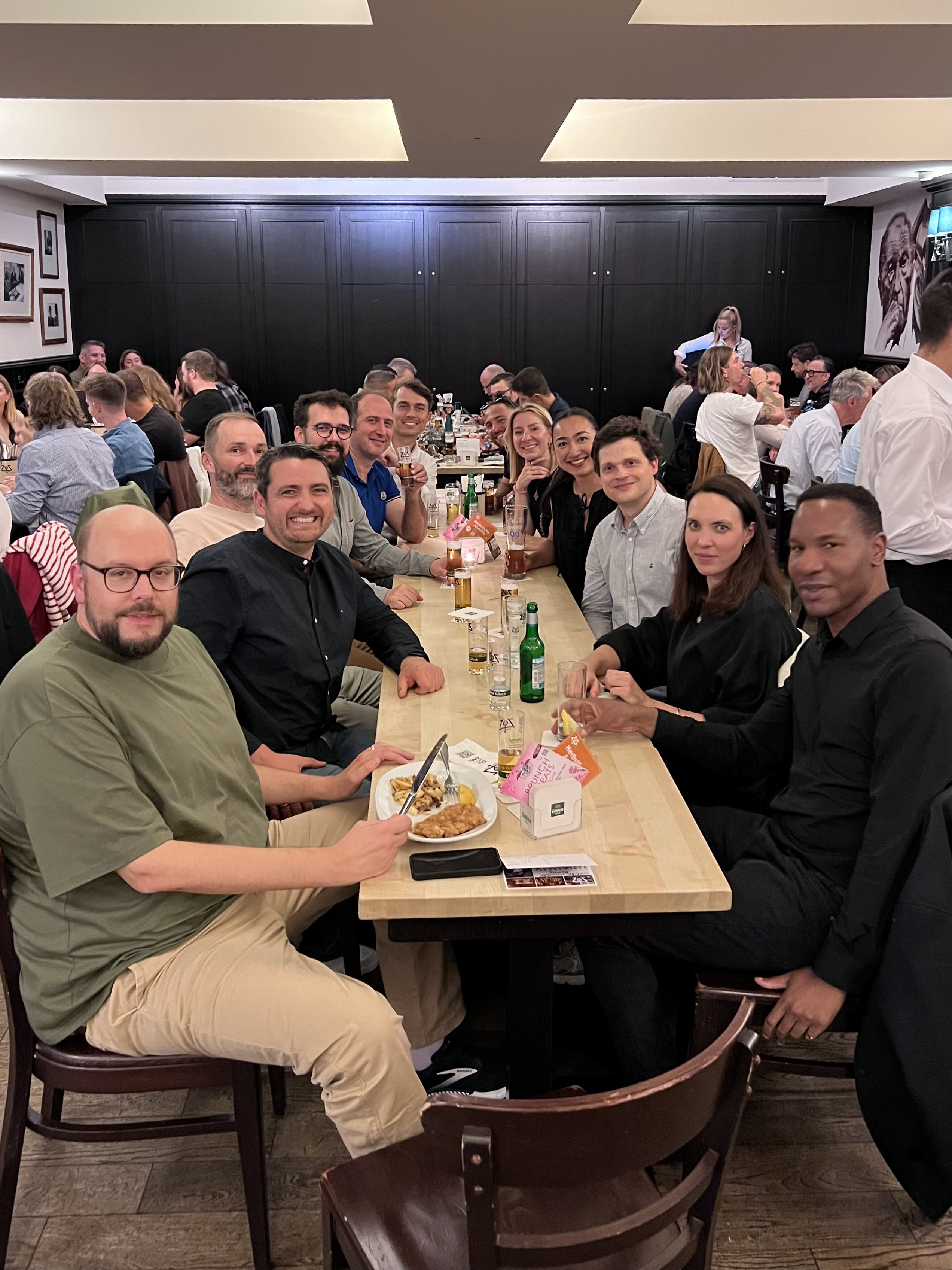 Magnolia team members and partners enjoying dinner and drinks around a table